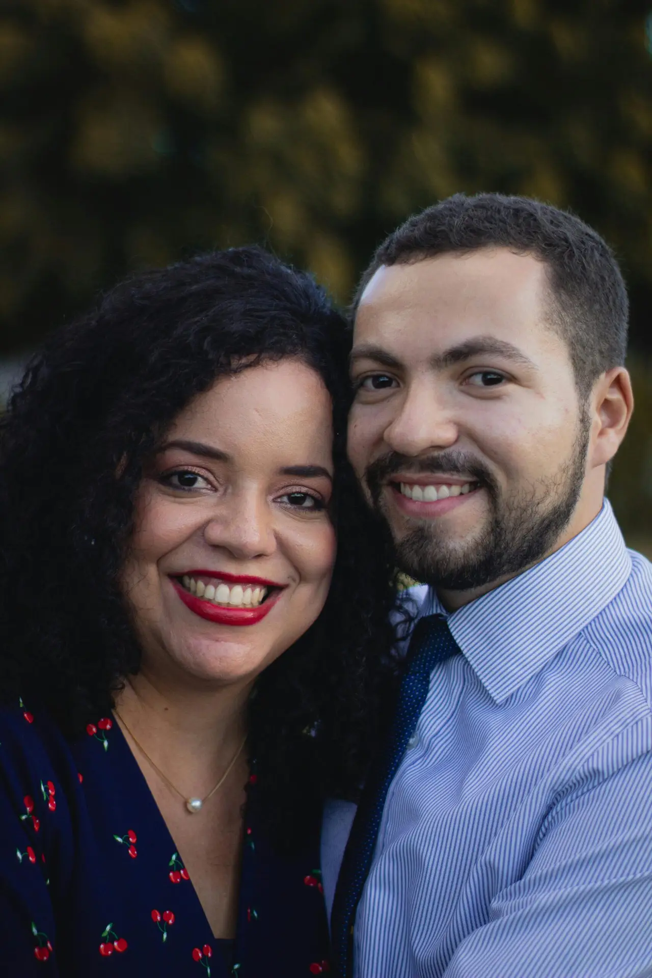 Smiling couple outdoors portrait, capturing a warm and affectionate moment.